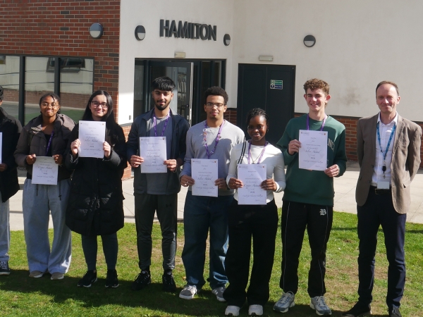 A level Chemistry students at Solihull Sixth Form College pick up certificates from Principal Martin Sullivan for success in the Cambridge Chemistry Challenge