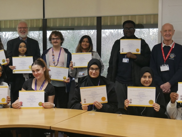 Solihull Sixth Form College students are presented with awards by Shirley Lions for volunteering